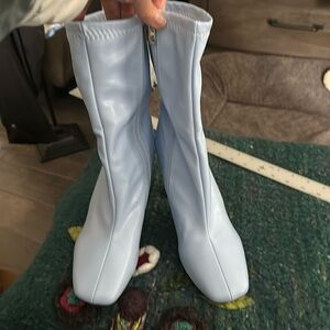 no brand, new boots. no pebbling on soles. 4-inch heel.